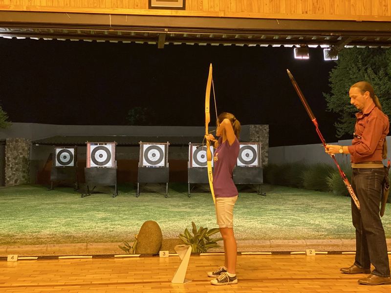 Coach working one-on-one with a junior archer